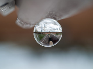 Reflections of one street in a park in a crystal ball / concept of environment