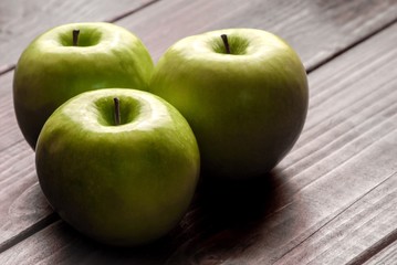 Green apples on a wood board