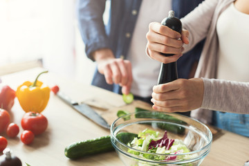 Closeup of couple cooking healthy food together