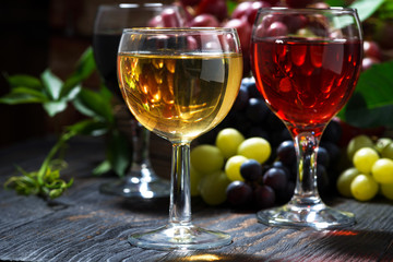 glasses of wine on dark wooden table, closeup