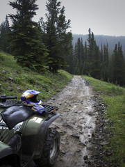 ATV/Fourwheeler on a Wet and Muddy Dirt Road © Sarah