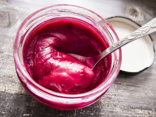 cream honey with berries in a jar