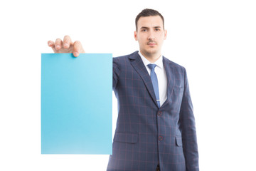 Handsome businessman or manager holding blank paper.