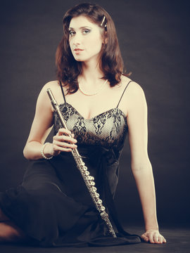 Elegant woman with flute instrument.