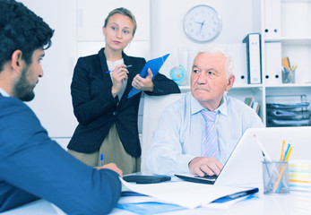 Old man is talking to colleague