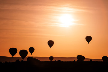 silhoutte of balloon on sunrise. famous hot air balloon flying over valley. Goreme, Cappadocia, Turkey.