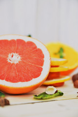 Close-up of juicy grapefruit with lemon on a wooden white table. Art soft focus and toned.