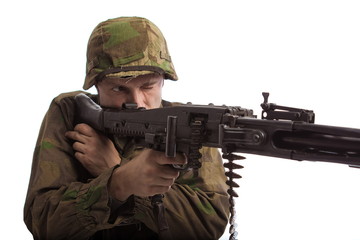 Man actor in the movie role of an old military man  with a MG 42 machine gun posing against white...