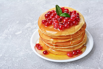 Tasty breakfast. Homemade pancakes with fresh cranberry, honey or maple syrup