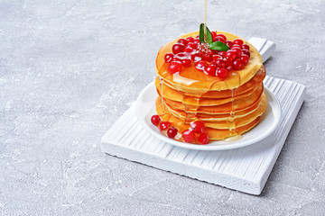 Tasty breakfast. Homemade pancakes with fresh cranberry, honey or maple syrup