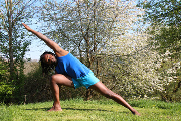 A man doing a Yoga exercise outdoors