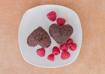 Two hearts of chocolate pie with raspberries.