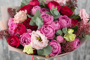 Close-up Beautiful Bouquet. Spring flowers on gray background. flower shop. Wooden table