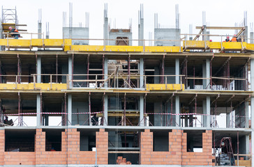 New residential building construction site with scaffolding and reinforcement in the city