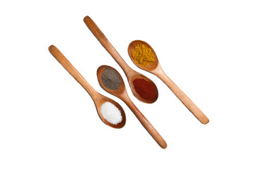 Several spices on wooden spoons isolated on white background