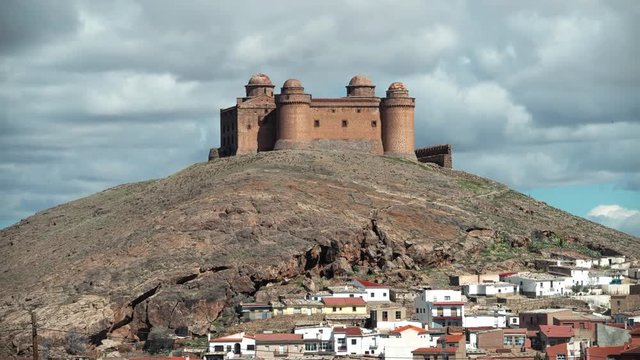 Calahorra castle timelapse, hikers and town in foreground, Andalucia Spain.