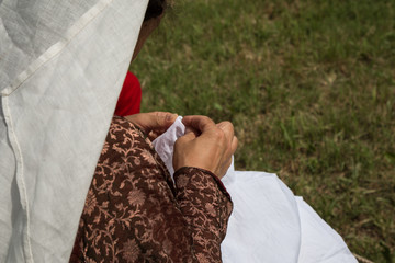 Woman with Renaissance Dress doing Needlework Outdoors