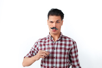 Crazy man with toy mustache posing at camera
