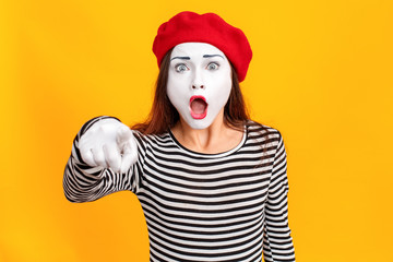 Closeup portrait of amazement mime woman pointing finger at camera