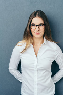 Young woman in white shirt wearing glasses