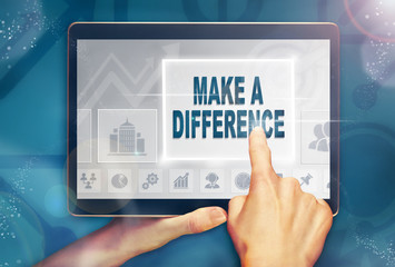 A hand holiding a computer tablet and pressing a Make A Difference business concept.