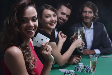 adult group celebrating friend winning blackjack - obrazy, fototapety, plakaty