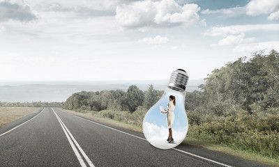 Businesswoman inside light bulb