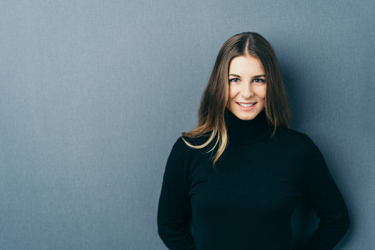 Young smiling woman wearing black roll neck jumper