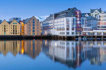 Architecture of Alesund town reflected in the water, Norway
