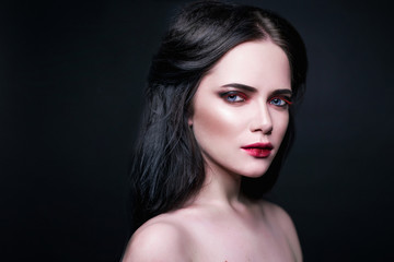 Beautiful portraits with a girl with make up and dark hair in studio