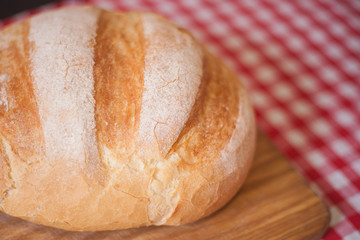 Crusty loaf at side view are on a wood table