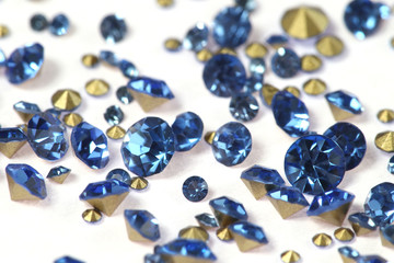Many scattered rhinestones. On a white background