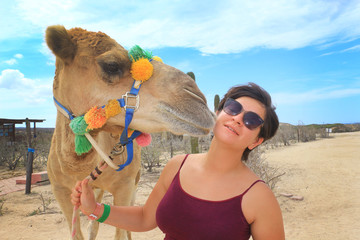 Beautiful girl on a tour with a camel. Mexico