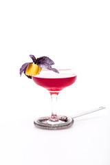 champagne cocktail at wineglass decorated with basil on white background