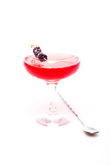 champagne cocktail at wineglass decorated with blackberry on white background