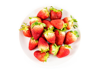 strawberries in white porcelain dish with white background