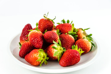 strawberries in white porcelain dish with white background