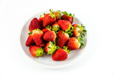 strawberries in white porcelain dish with white background