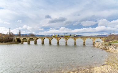 Fototapeta premium The train as it passes through Arija, Burgos, Spain 
