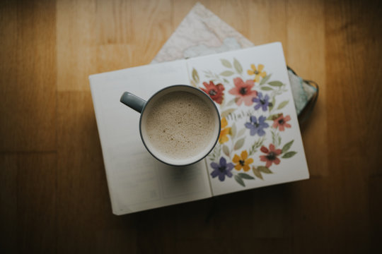 Cup of warm drink on book
