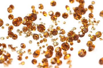 Many scattered rhinestones. On a white background