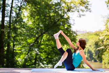 Yoga woman on green park.