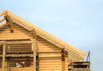 Process of wooden house straight roof slope mounting. Wooden country house construction