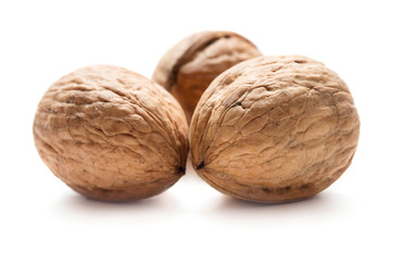 three ripe walnuts isolated on white background