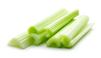 heap of green celery stiks isolated on white background
