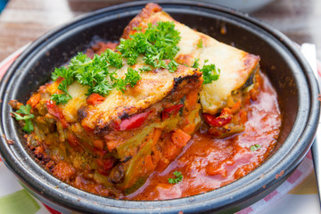 Fresh cook Lasagne bolognese serve on black circle plate.