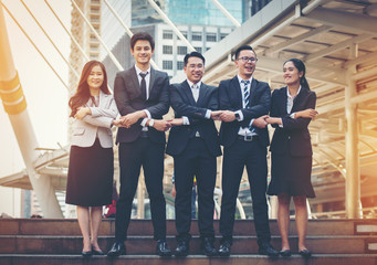 Fototapeta premium Business team up and holding hands on the ladder.