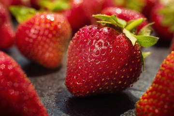 strawberries on stone background, delicious first class organic fruit as a concept of summer vitamins