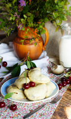 dumplings with cherry, on the old wooden table, rustic style