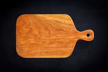 Cherry wood cutting board on a black wooden board,handmade wood cutting board